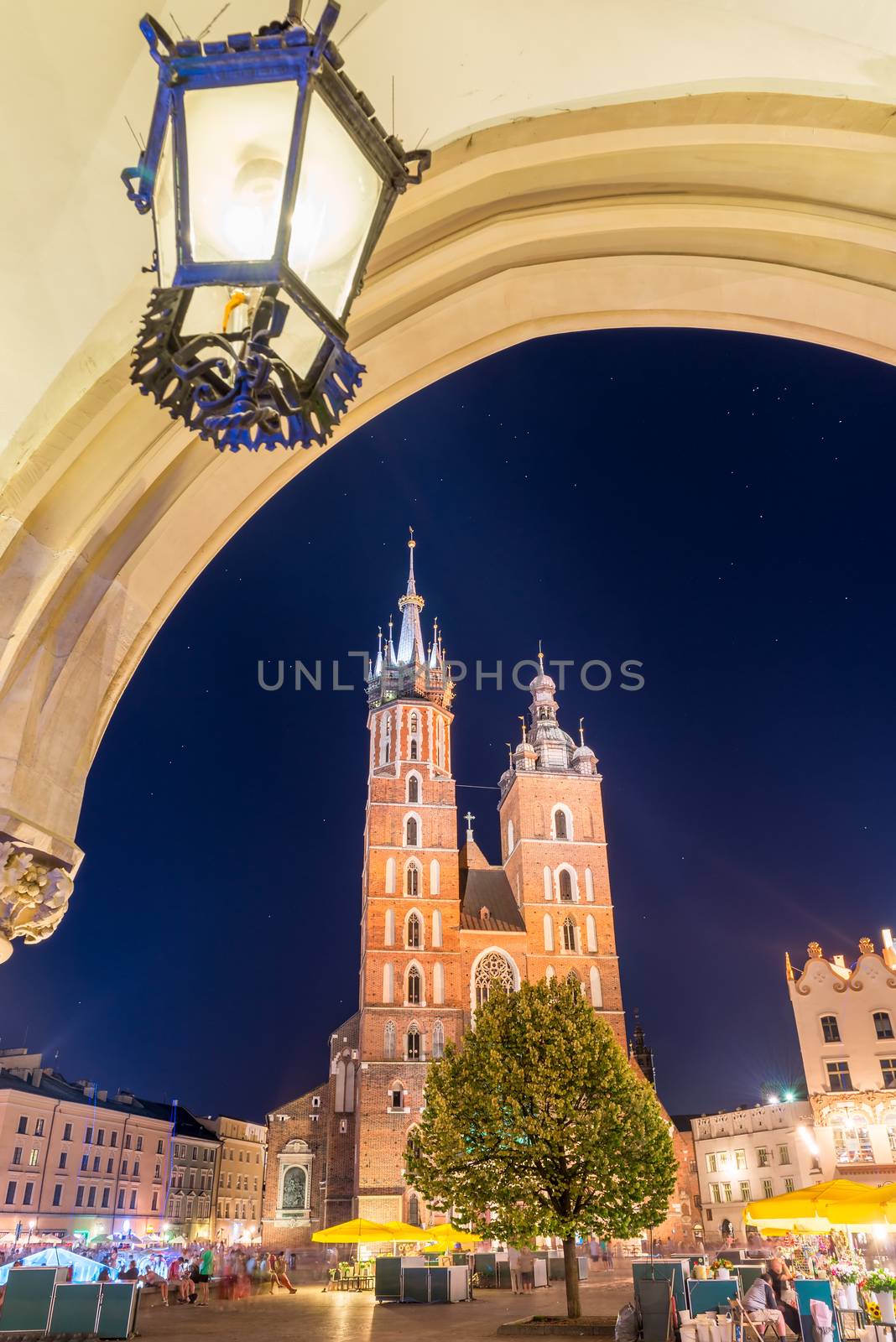 arch with lamp, night photo of the Mariak Church in the center of Krakow, Poland