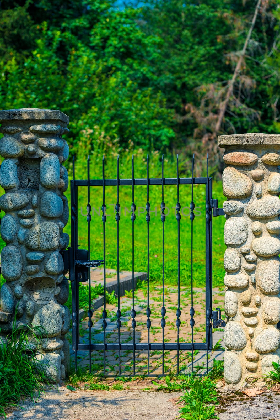 architectural element - wrought iron wicket and pillars trimmed with decorative stone