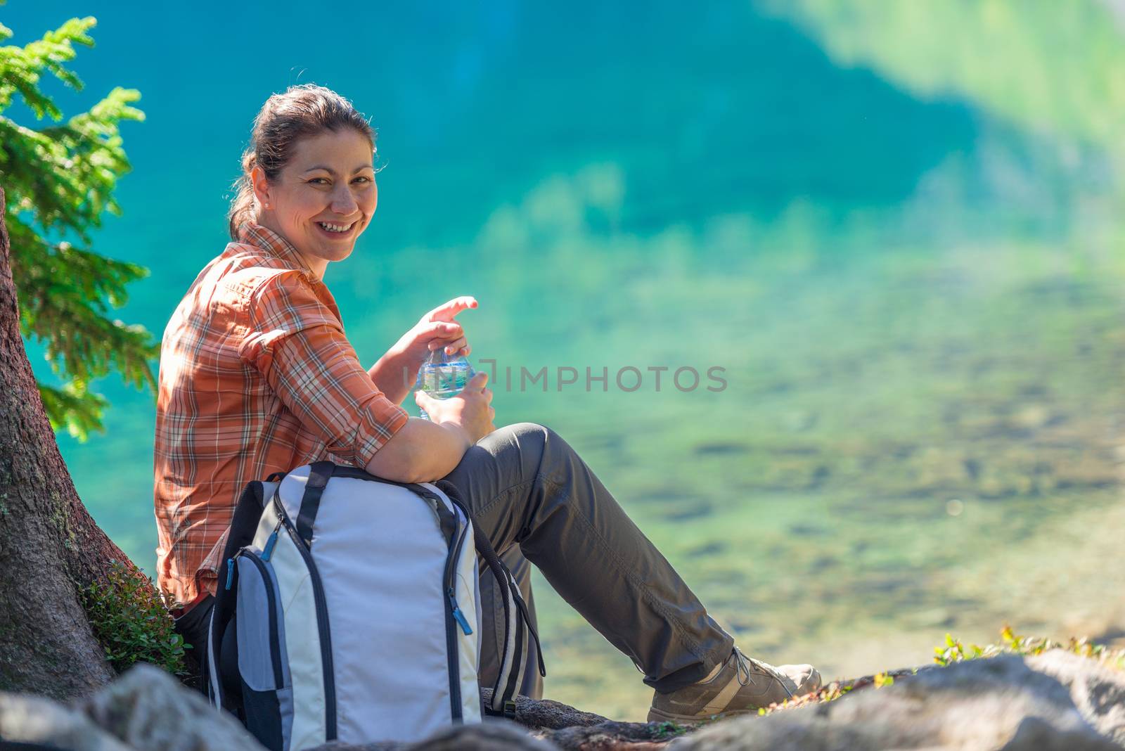 happy tourist with a bottle of water admires the beautiful mount by kosmsos111