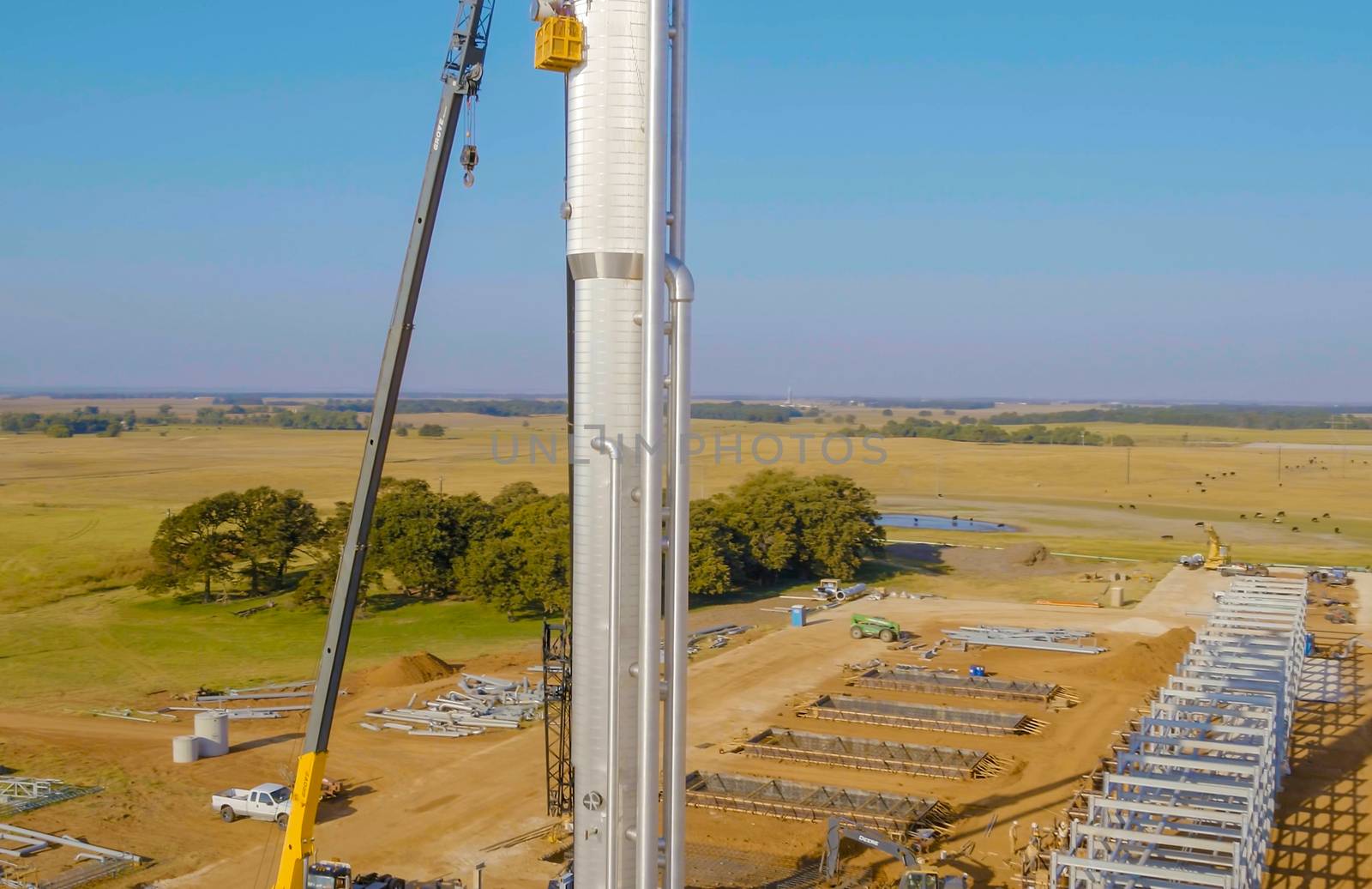 Installation of the distillation column with a lift crane. Construction of an oil refinery.