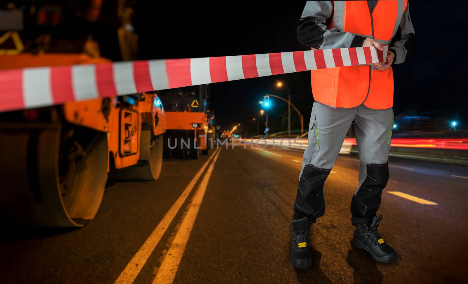 Workers on a road construction, repairing the road in the night city