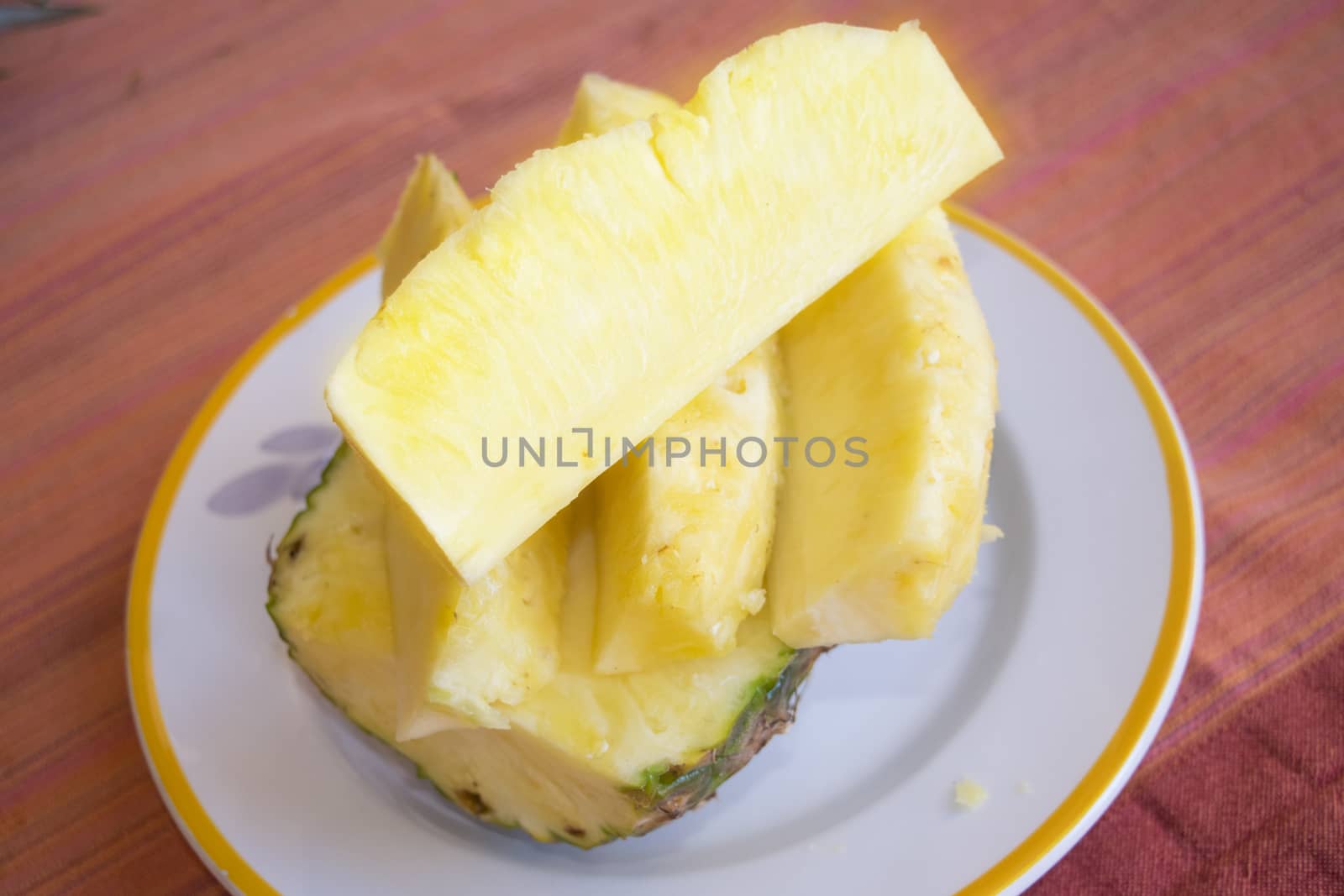 heap of fresh sliced pineapples in a white dish