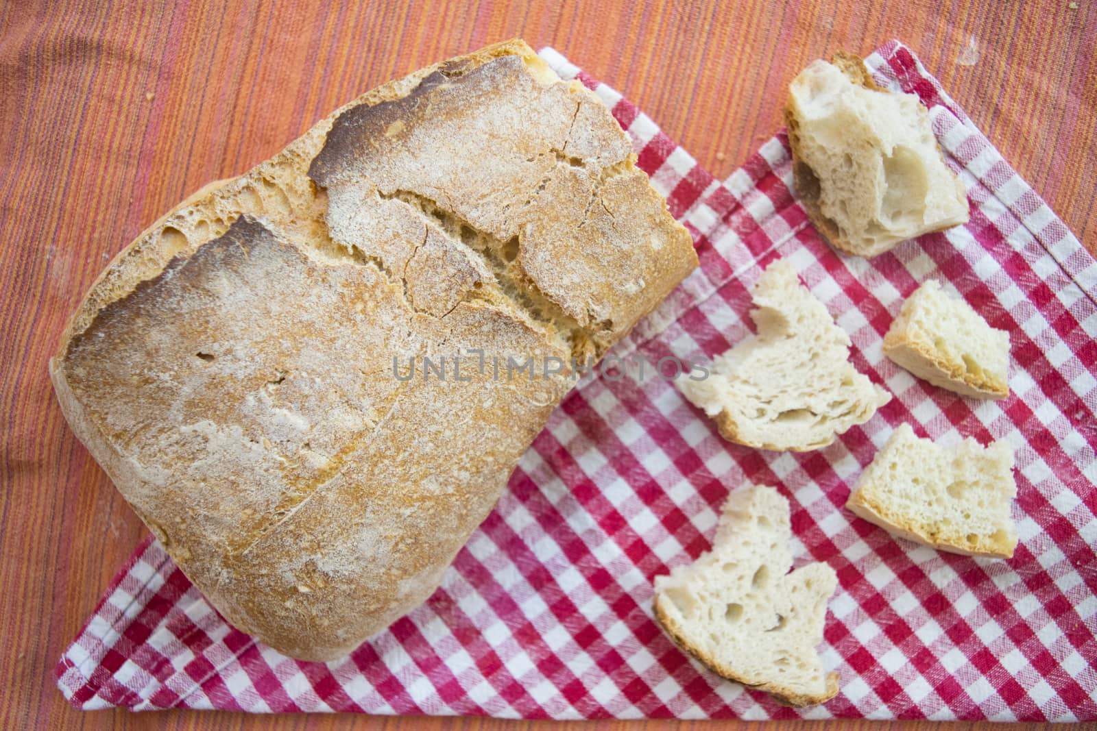 loaf of french bread with near some small pieces of it