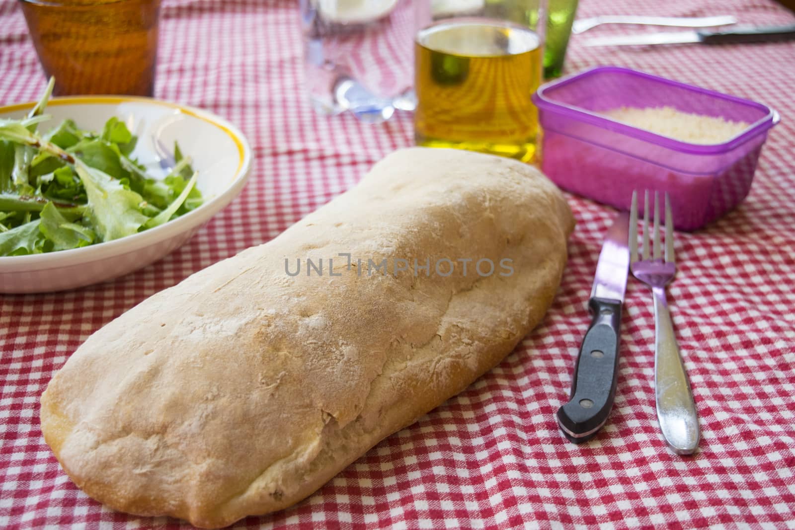 homemade long loaf bread on a set table 
