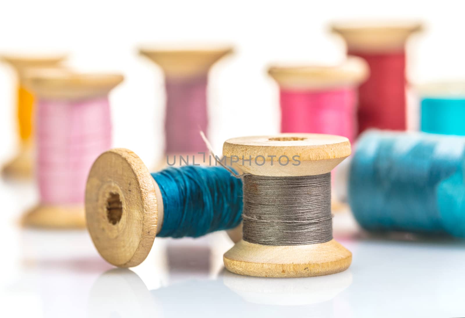 coils with colorful thread on white background