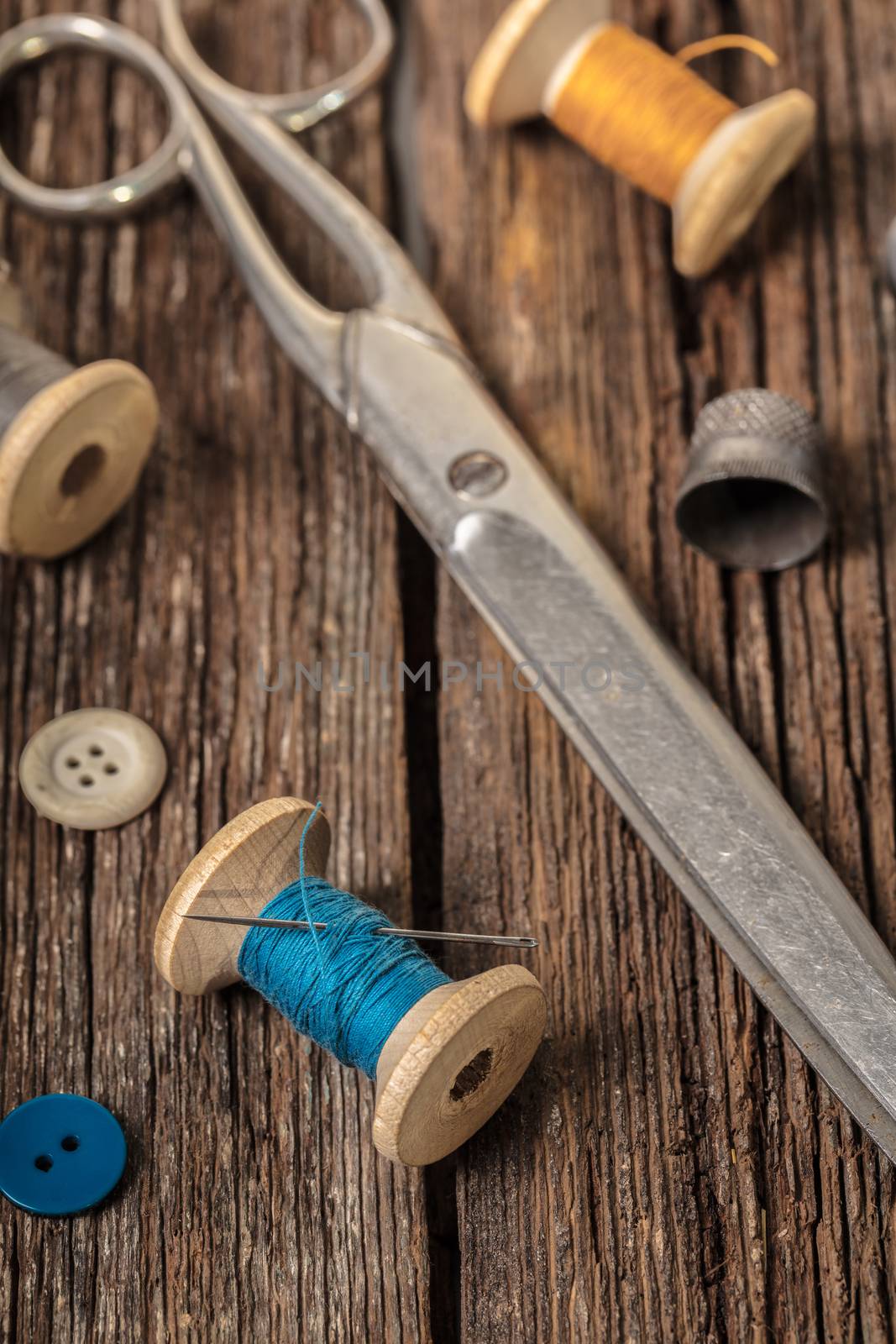 scissors and sewing accessories on a wooden background