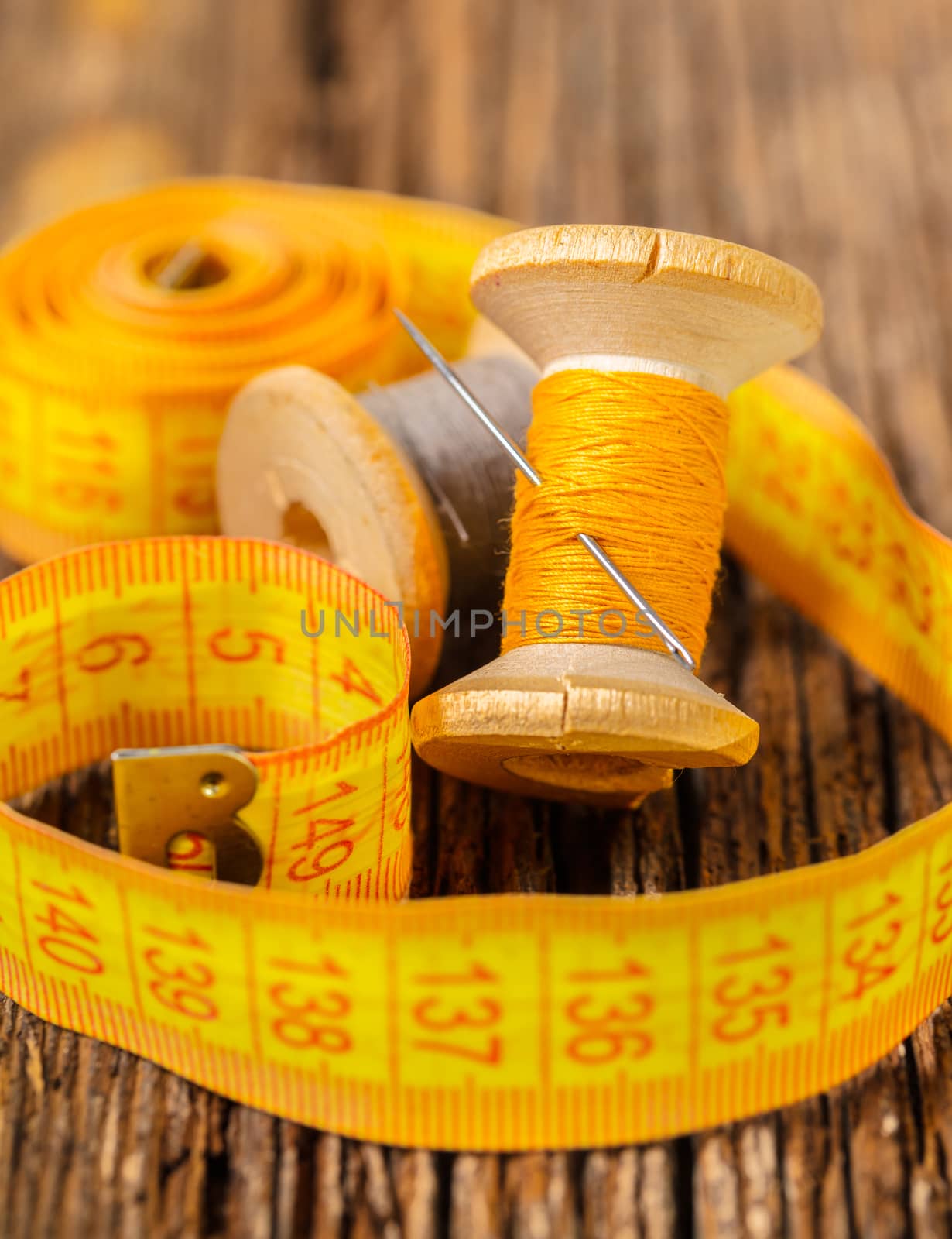 colored thread and meter on a wooden background