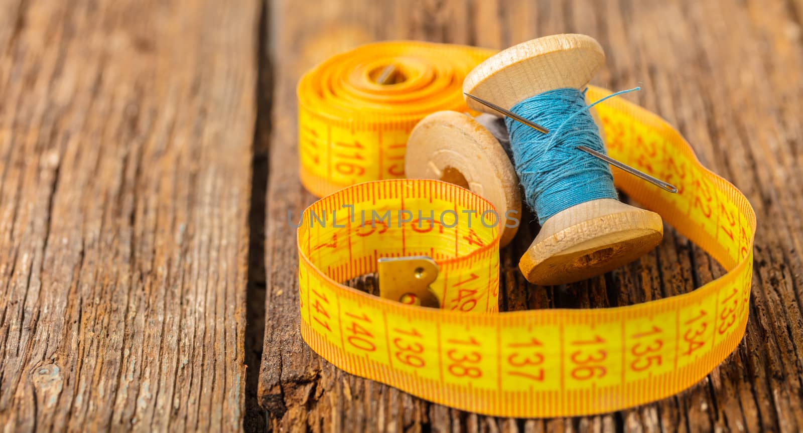 colored thread and meter on a wooden background