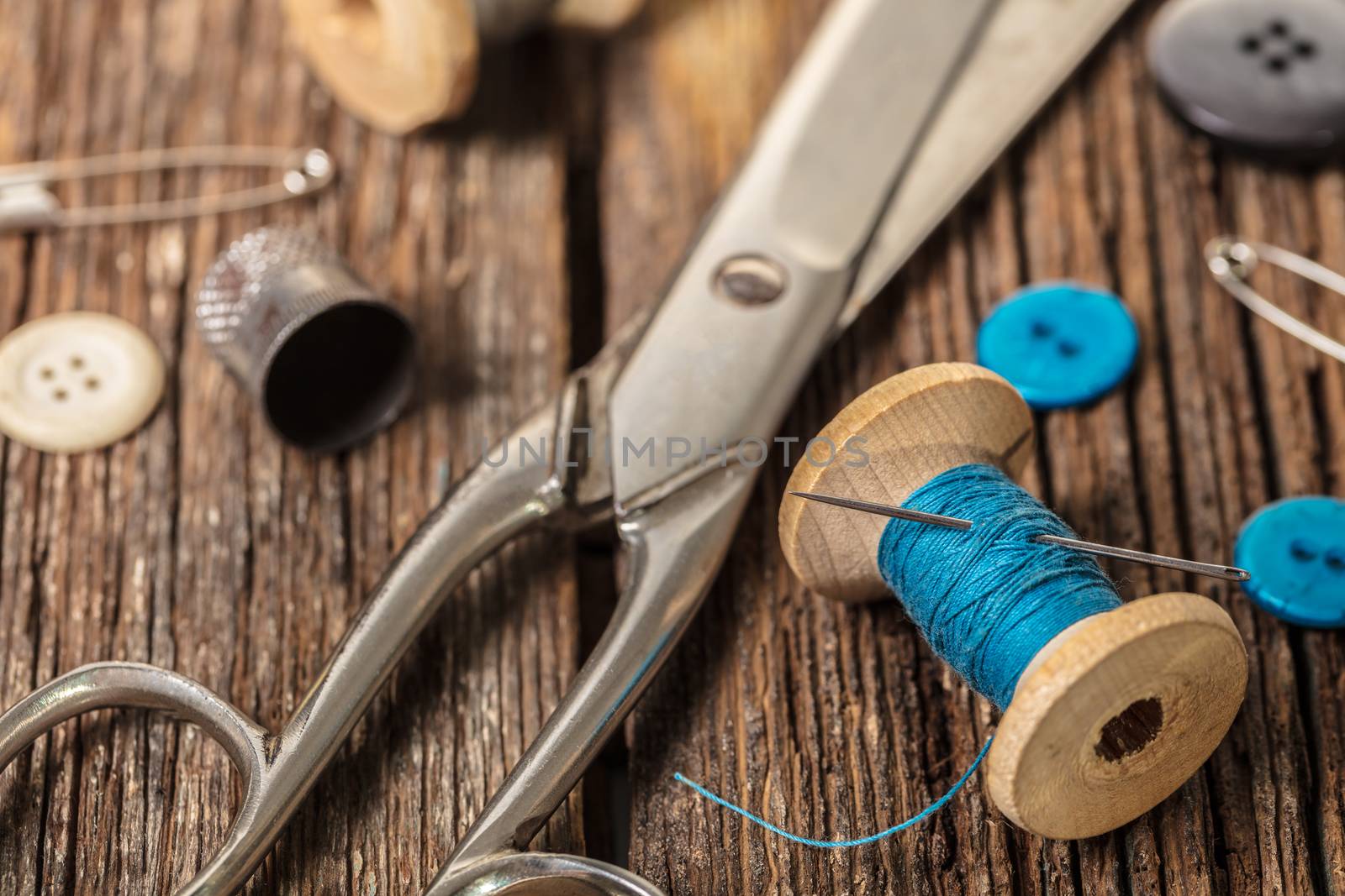 thread and sewing accessories on a wooden background