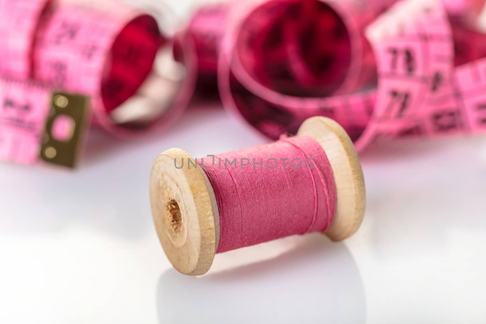 spool of pink thread and meter  by MegaArt