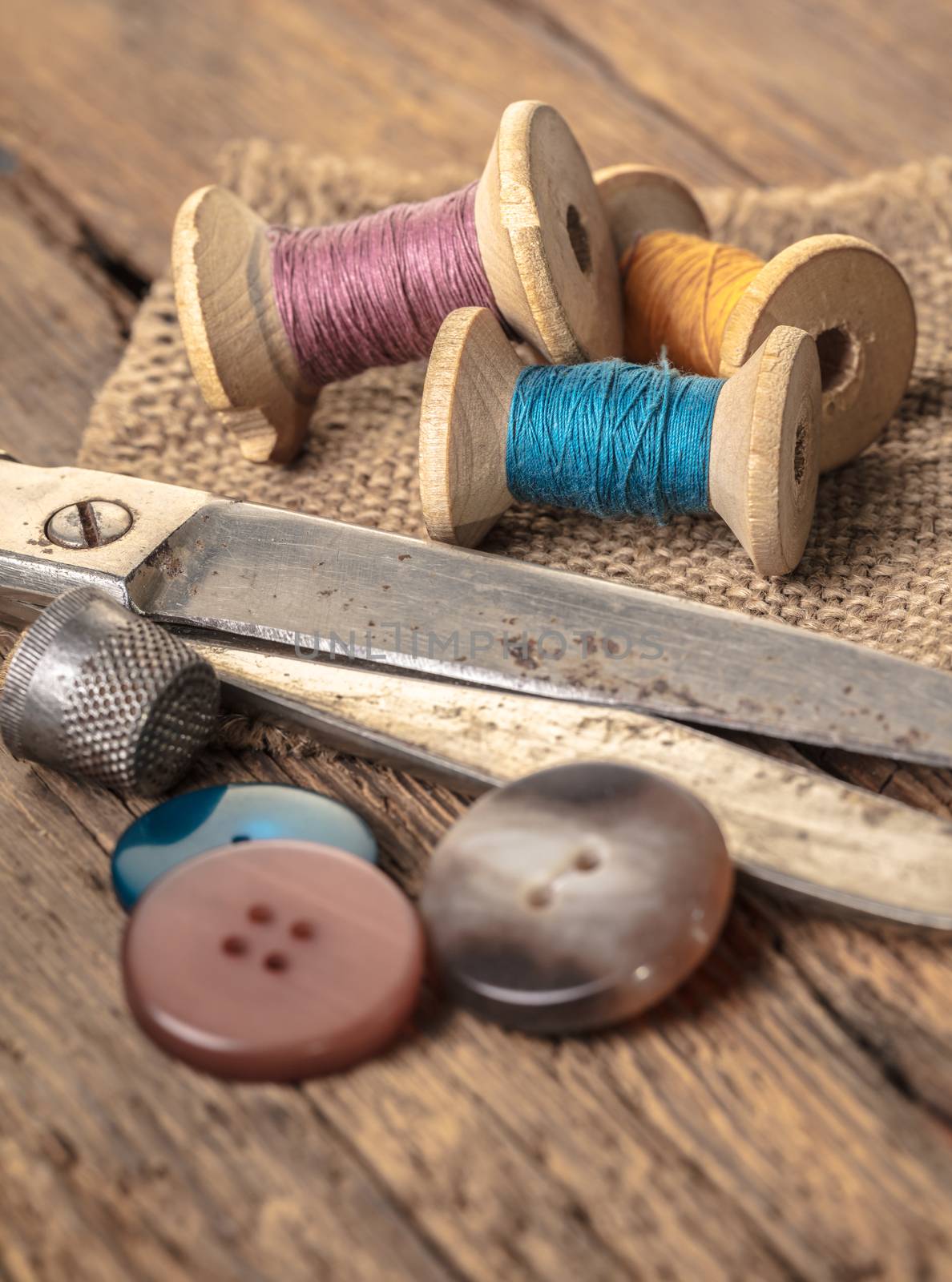 scissors and sewing accessories on a wooden background