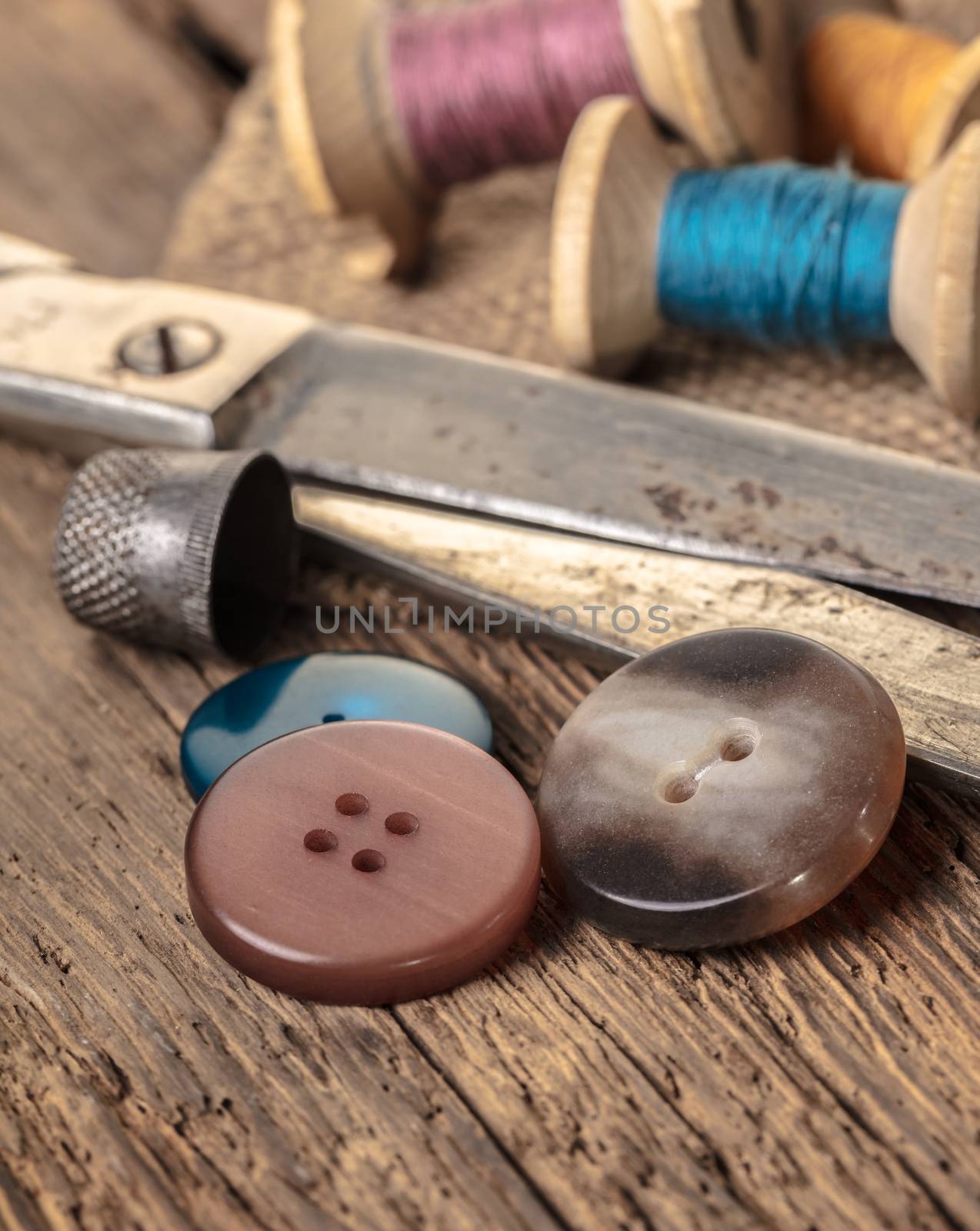 scissors and sewing accessories on a wooden background