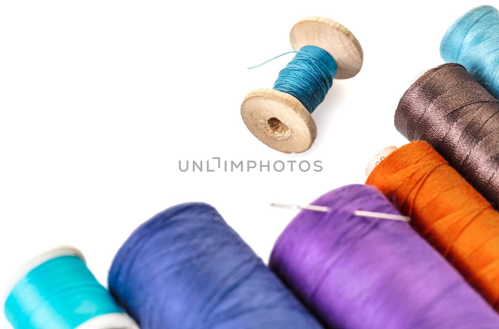 spools of colorful threads on a white background