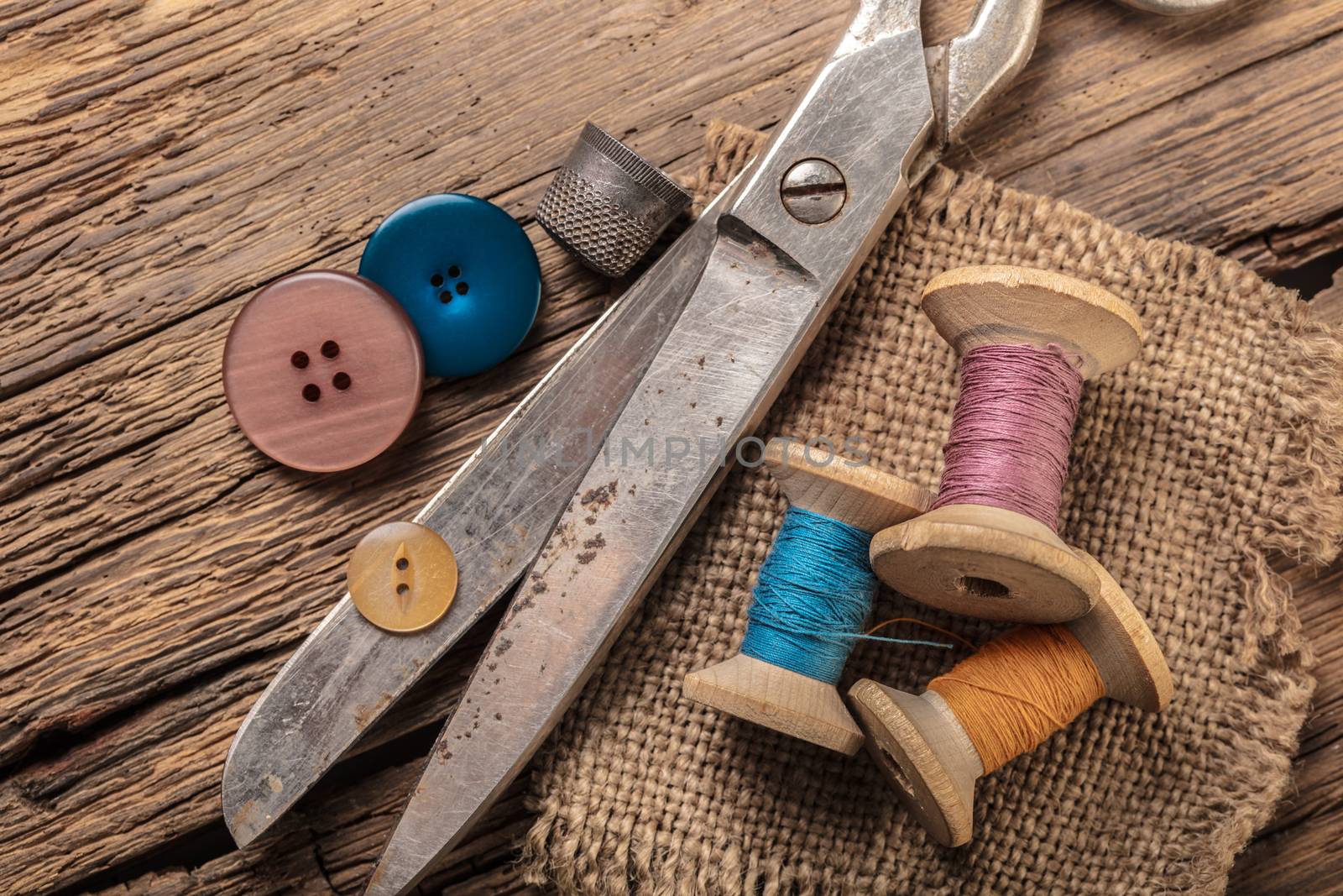 scissors and sewing accessories on a wooden background