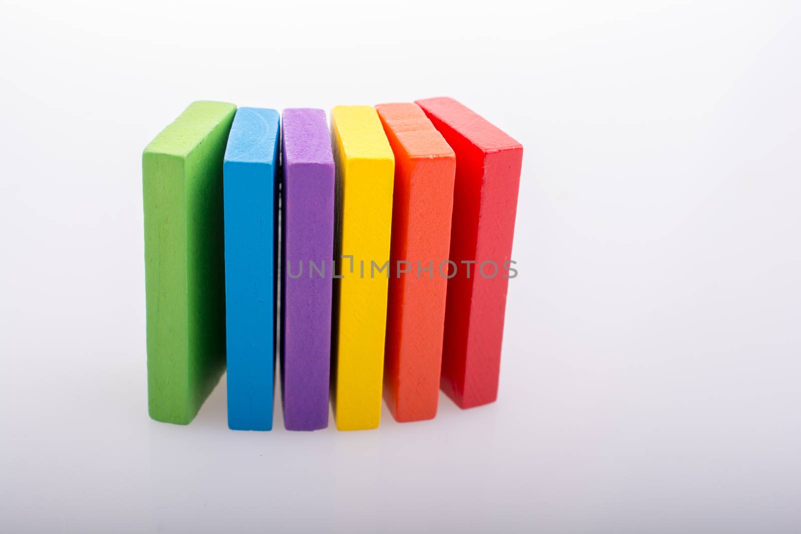 Colorful Domino Blocks in a line on a white background