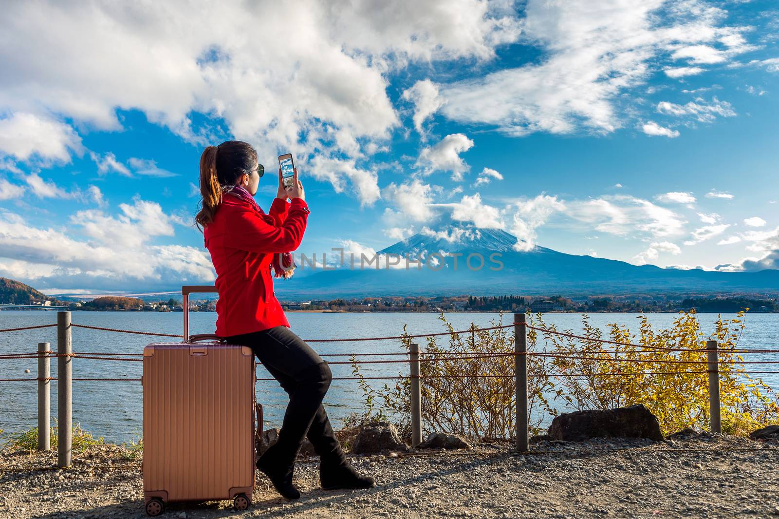 Woman take a photo at Fuji mountains. Autumn in Japan. Travel concept.