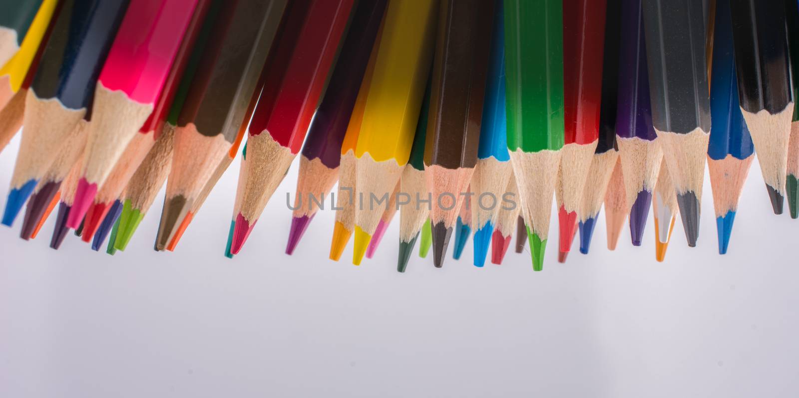 Color Pencils  of various colors on a  white background