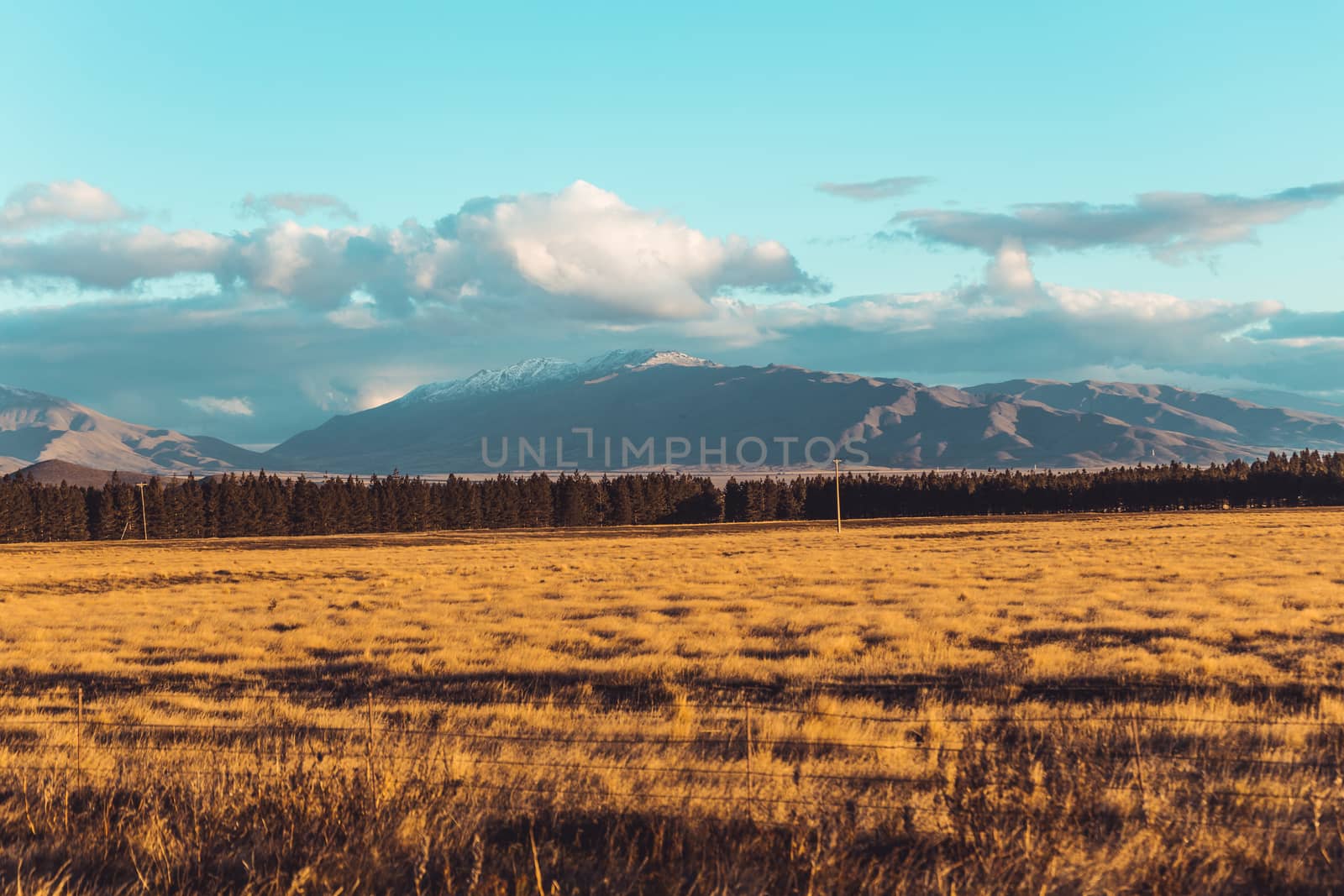 Road travel in the green mountains of New Zealand view from car window. Scenic peaks and ridges. Beautiful background of amazing nature.