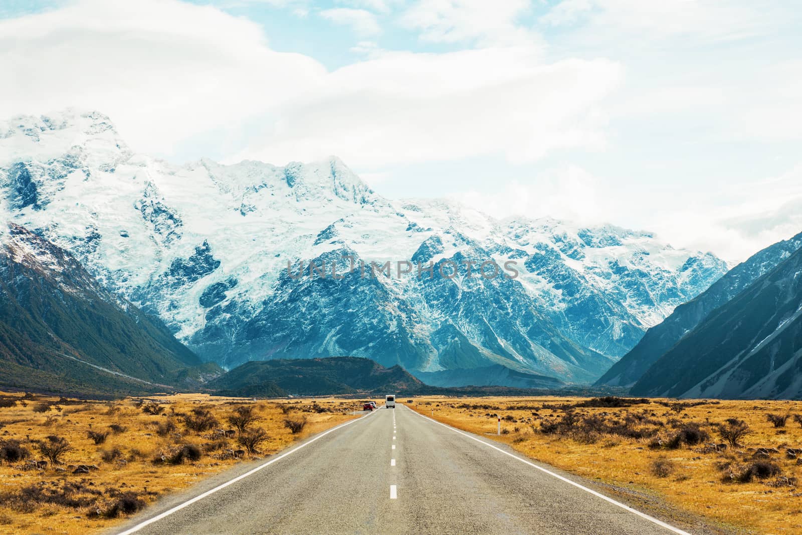 Road travel in the green mountains of New Zealand view from car window. Scenic peaks and ridges. Beautiful background of amazing nature.