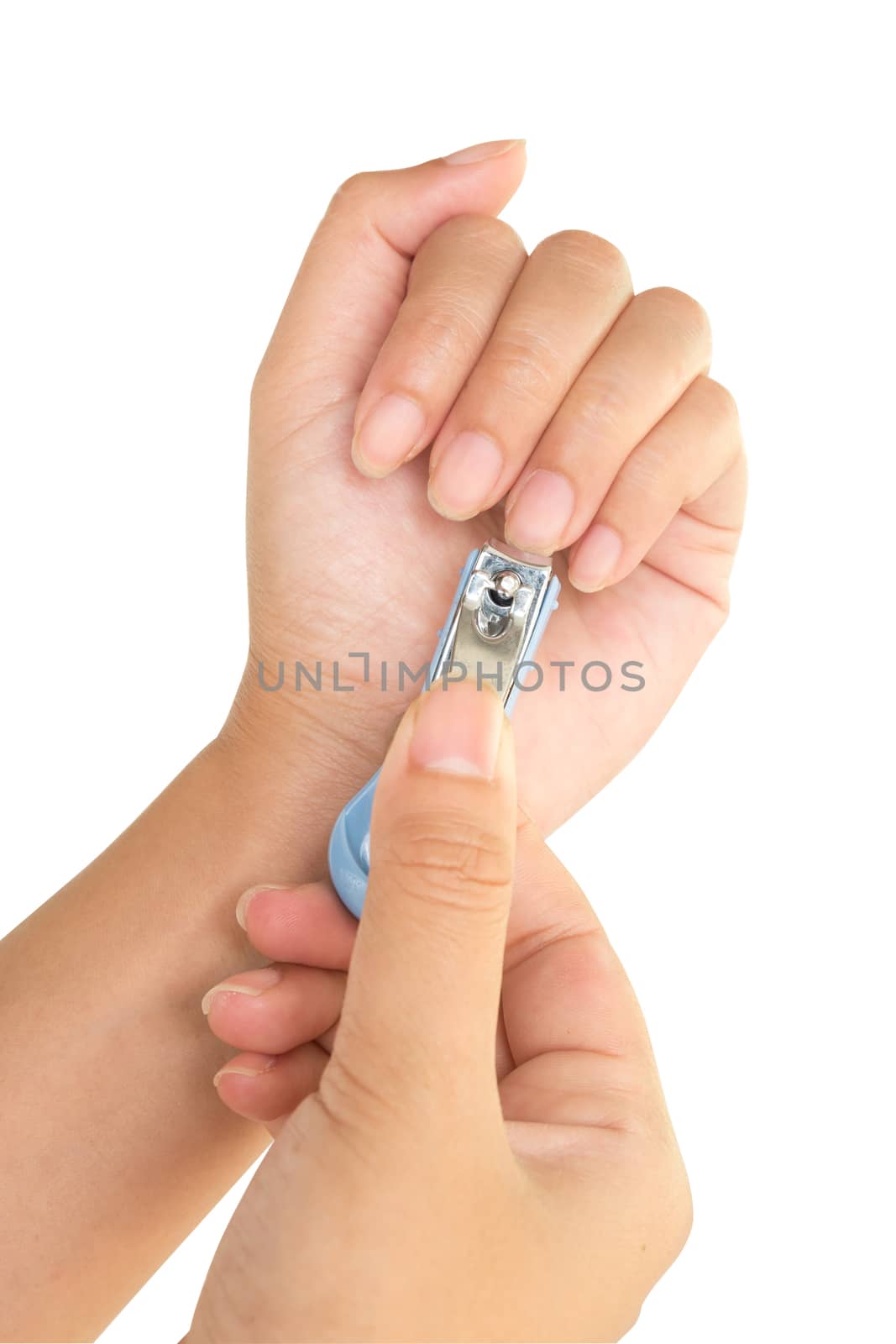 Hand manicure with nail clipper on white background.