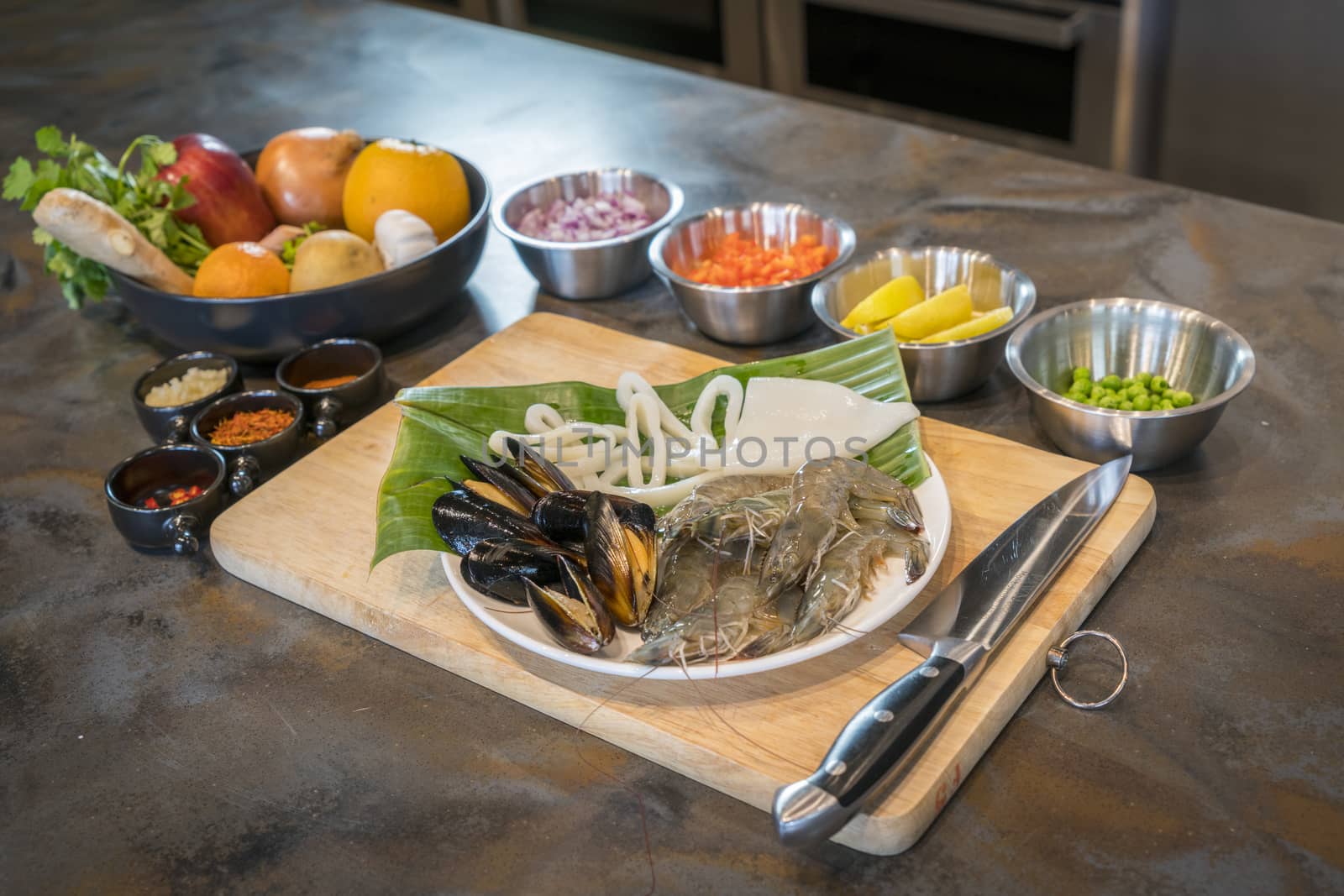 Raw seafood on plate with fruits and vegetables, healthy food, prawn, clam squid.