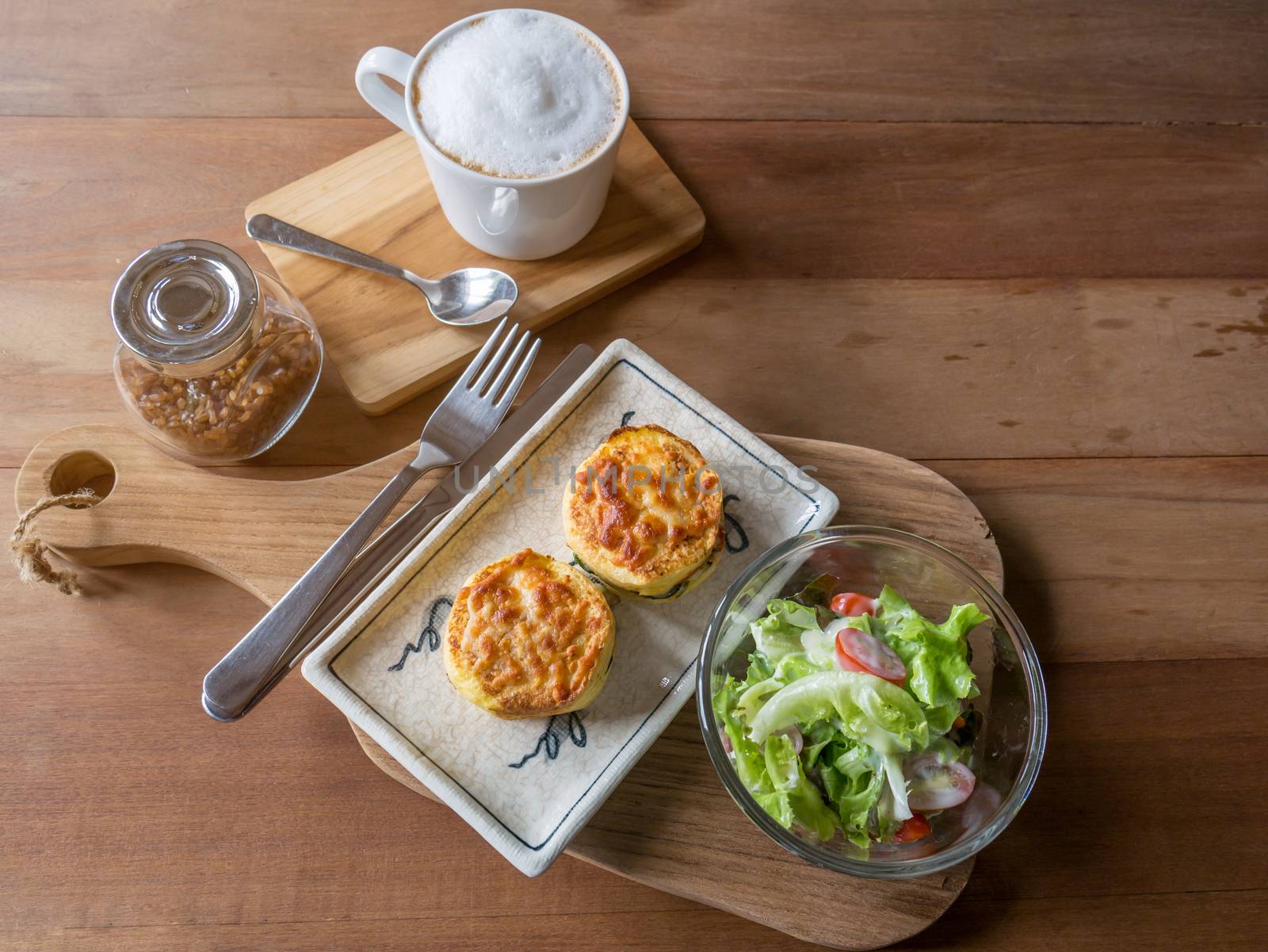 Set of food,salad ,baked spinach with cheese and coffee on wooden saucer