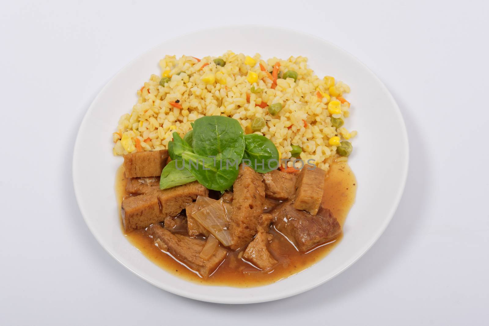 Tempeh with tomato sauce and millets on a white background