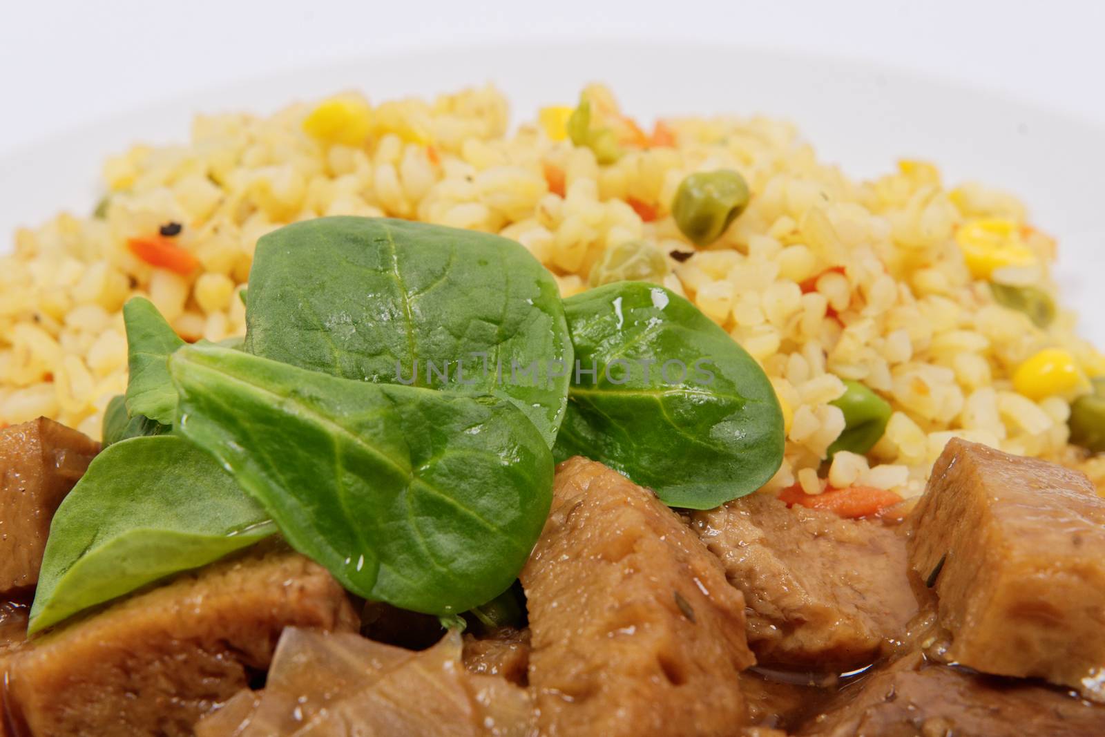 Tempeh with tomato sauce and millets on a white background