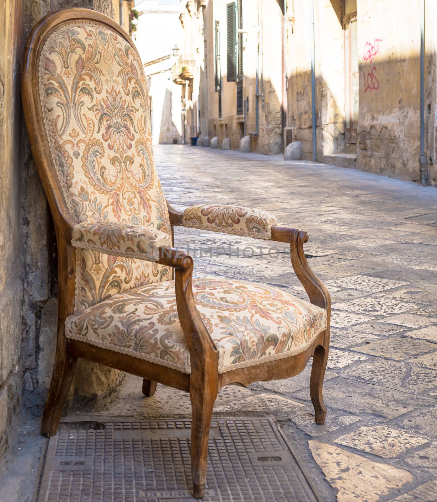 Old chair in a traditional street of Lecce, Italy. by Perseomedusa