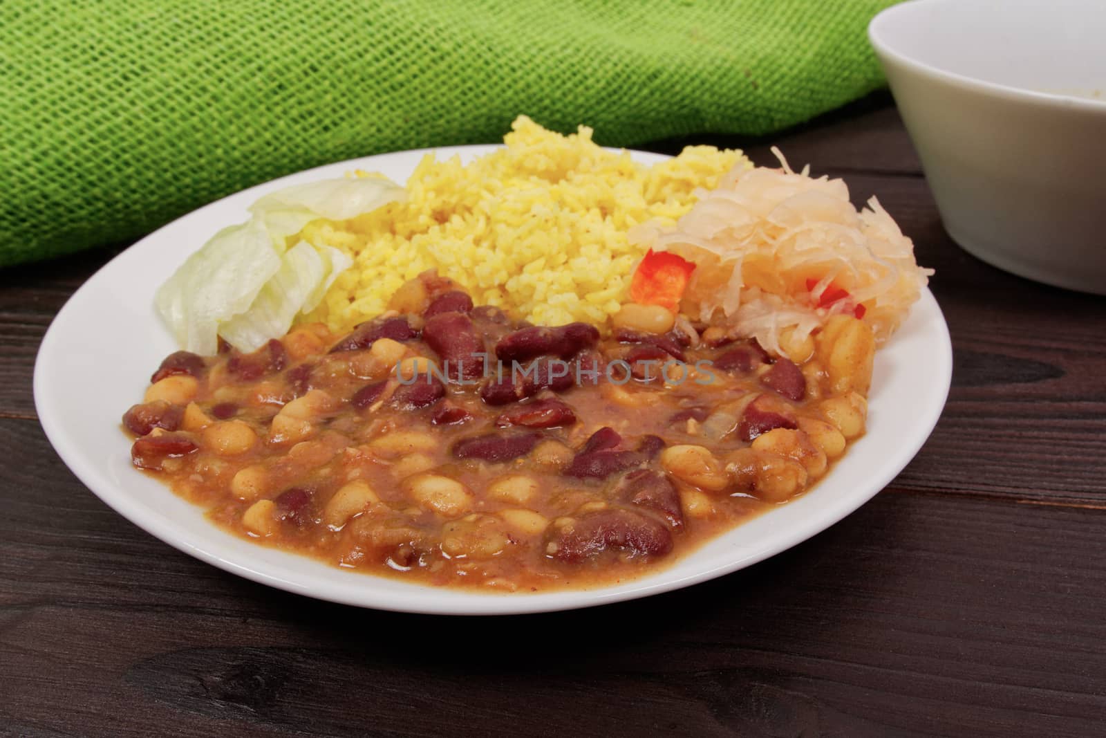 Red beans with curry rice on a wooden table