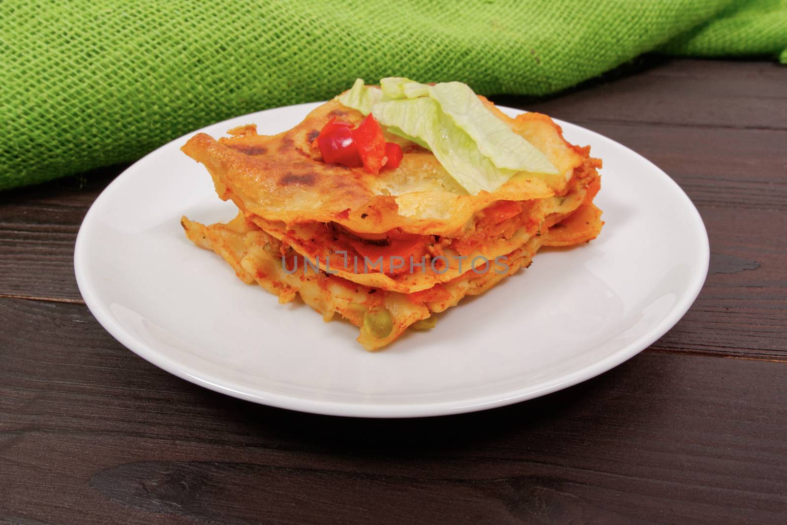 Lasagna with vegetables on a wooden table