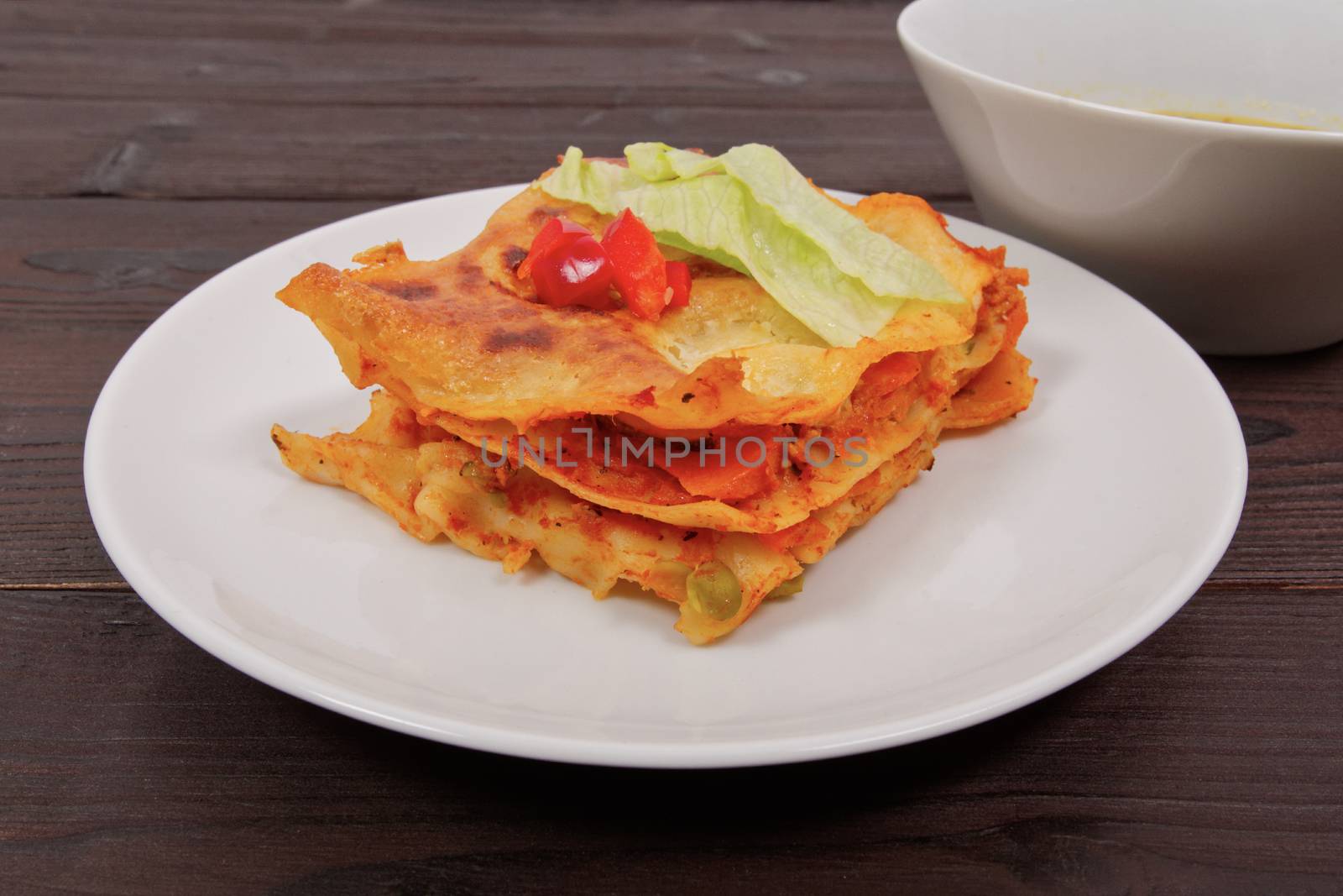 Lasagna with vegetables on a wooden table