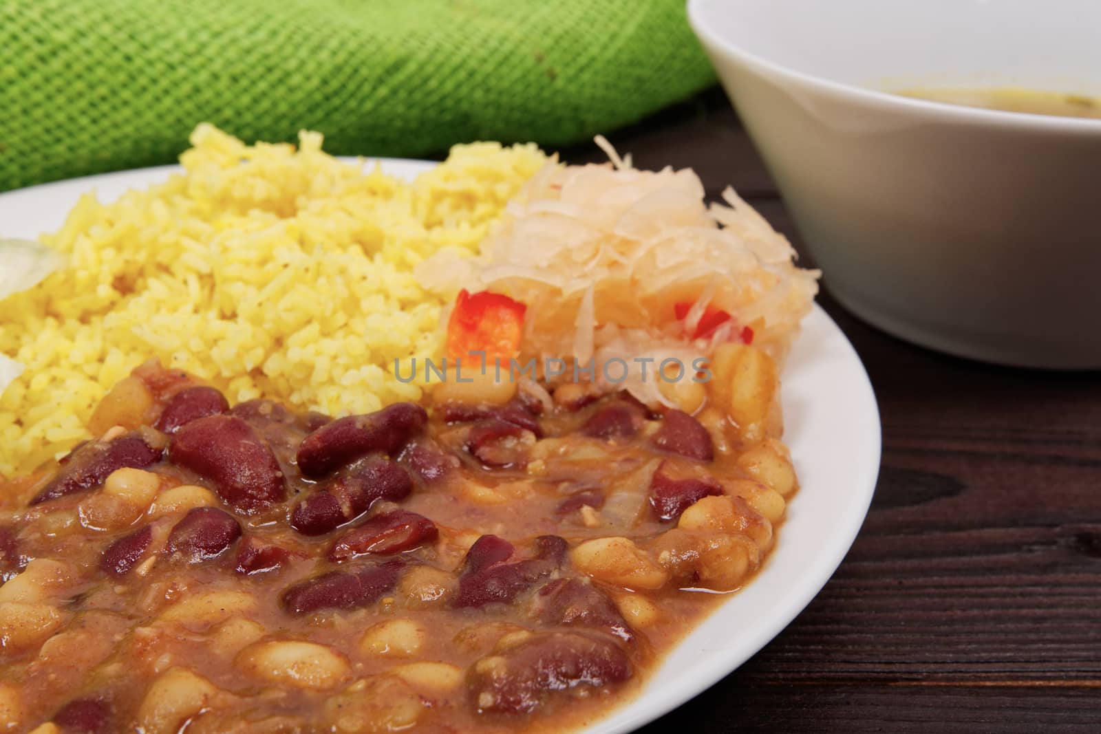 Red beans with curry rice on a wooden table