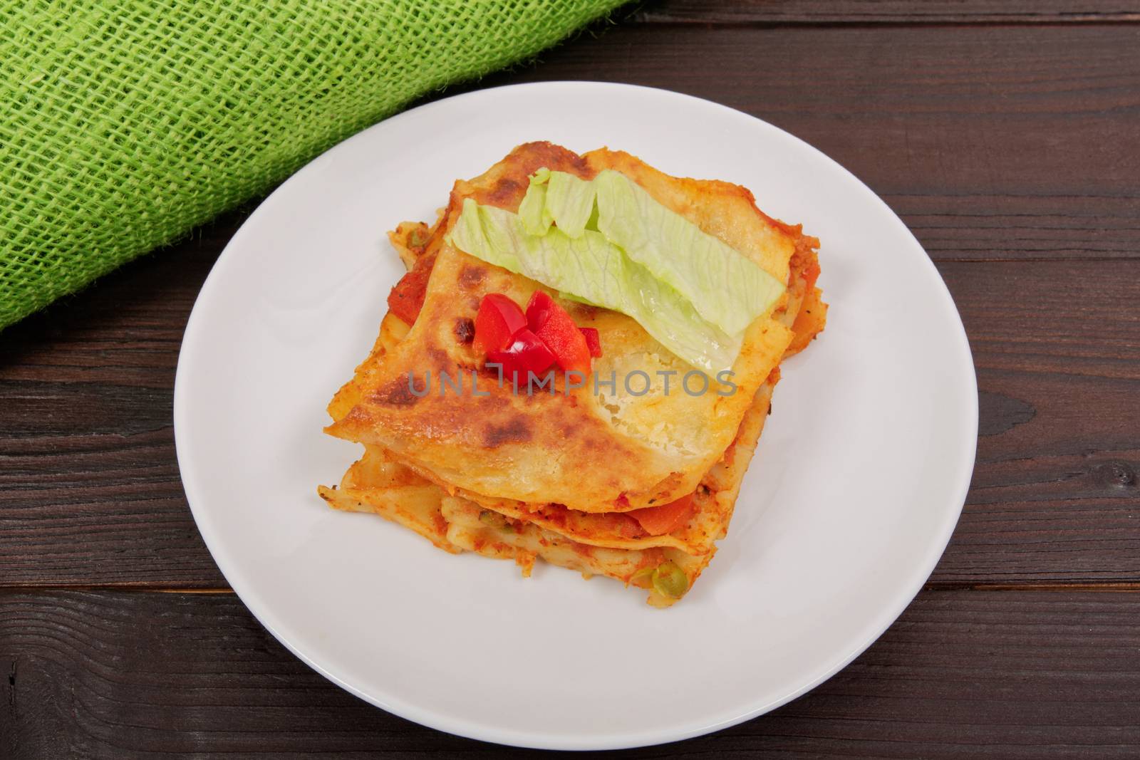 Lasagna with vegetables on a wooden table