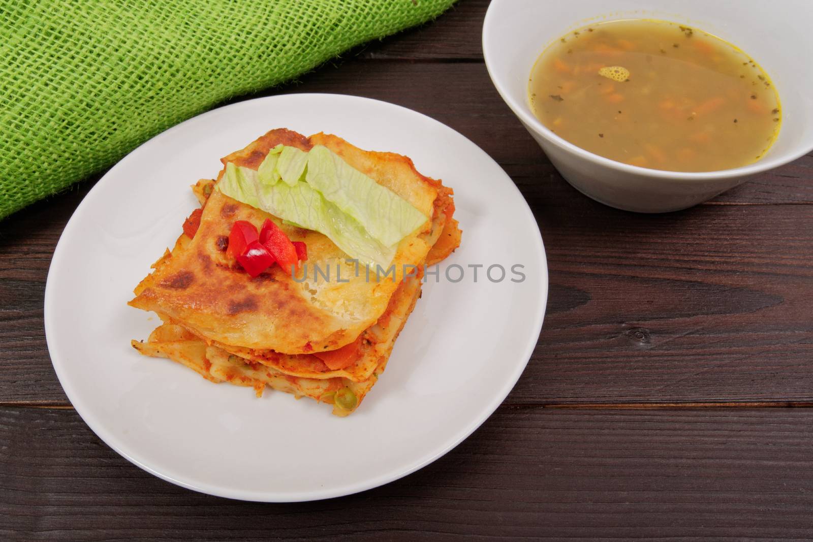 Lasagna with vegetables on a wooden table