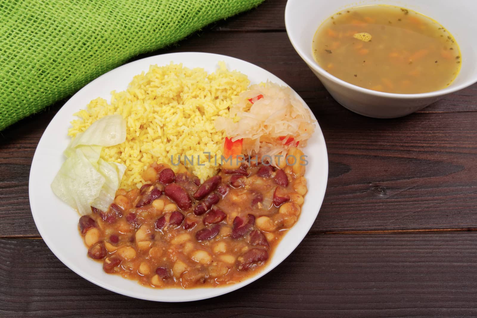 Red beans with curry rice on a wooden table