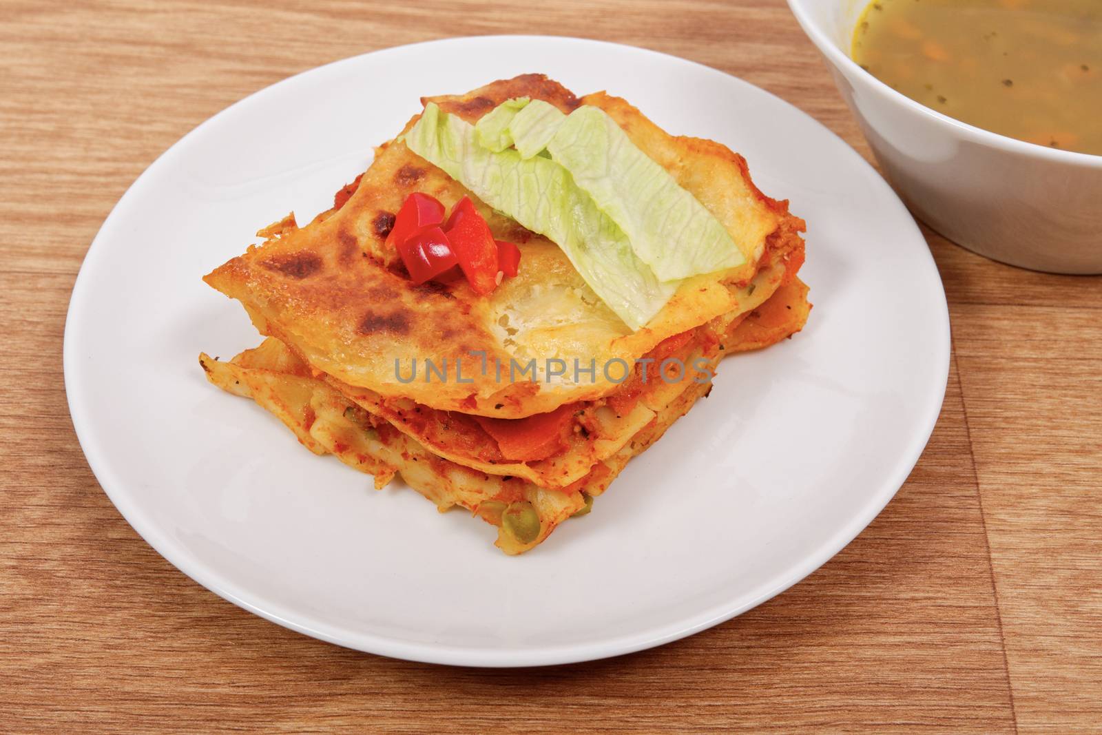 Lasagna with vegetables on a wooden table