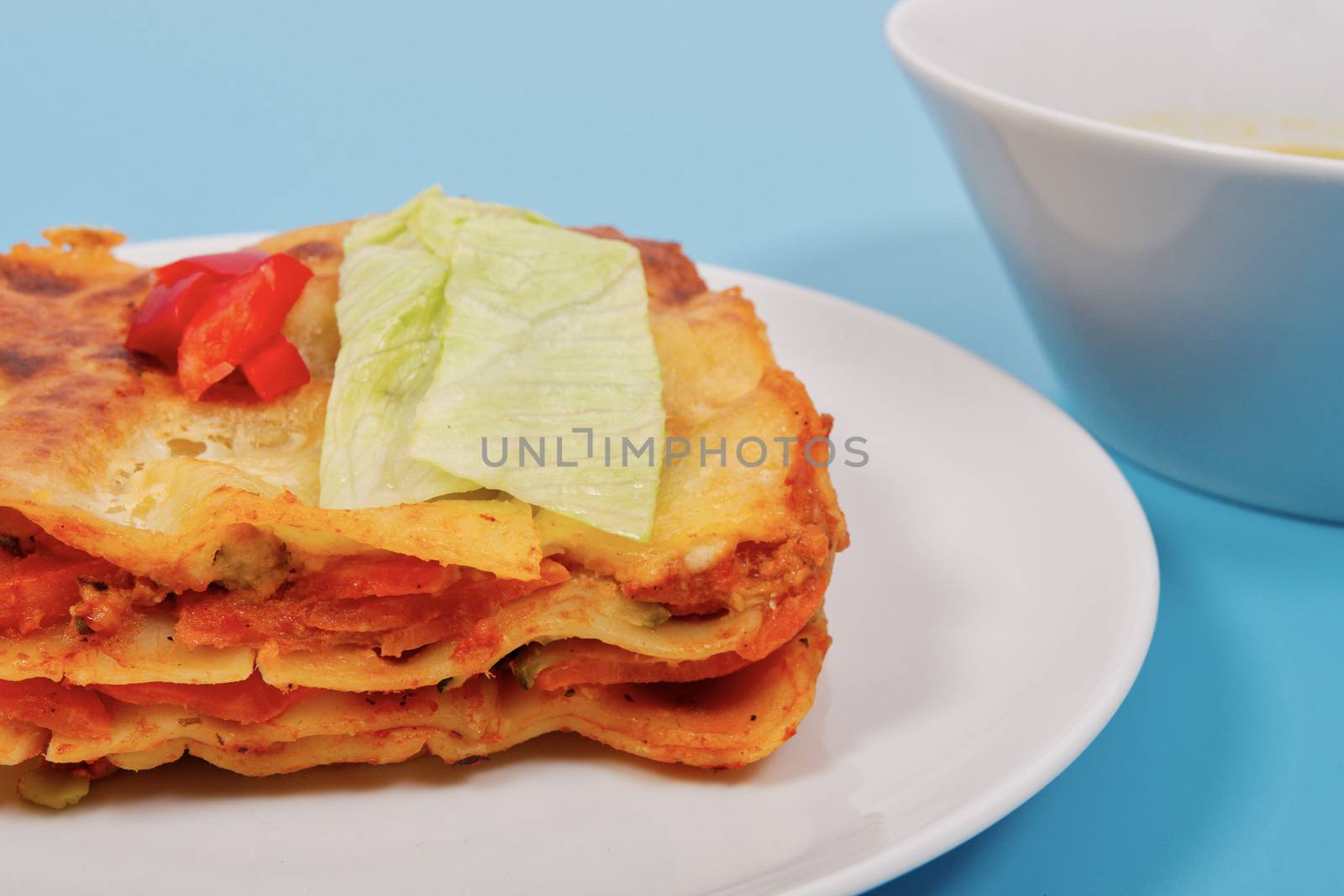 Lasagna with vegetables on a blue by neryx