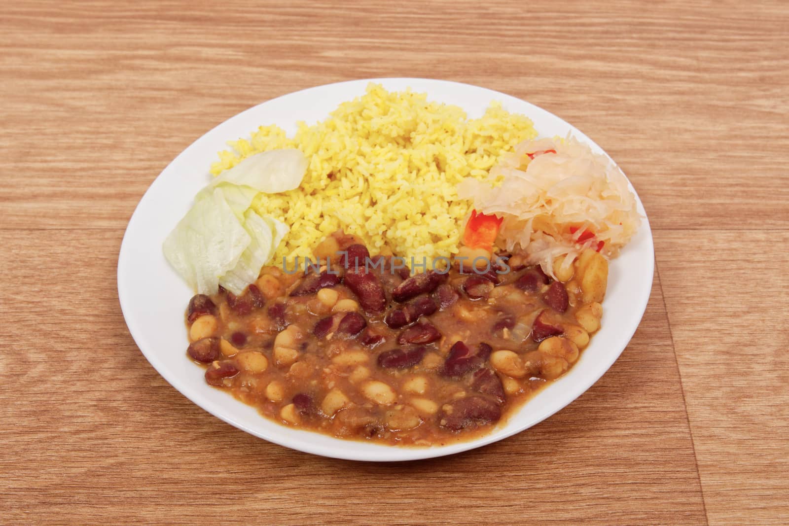 Red beans with curry rice on a table by neryx