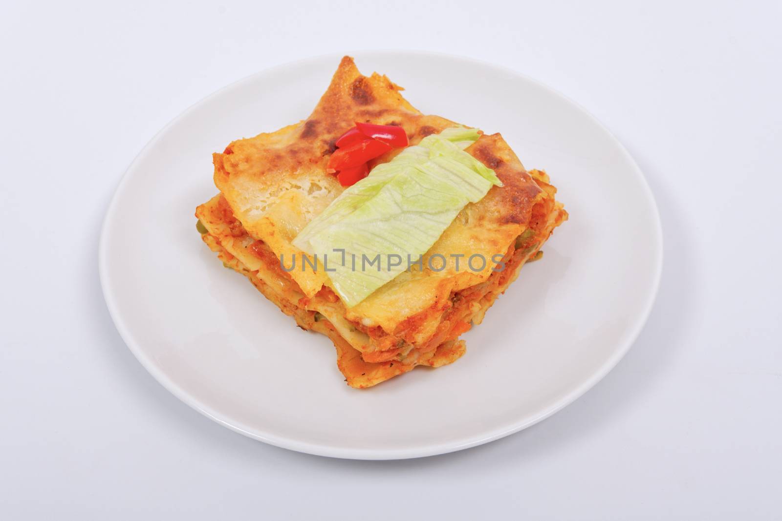 Lasagna with vegetables on a white by neryx