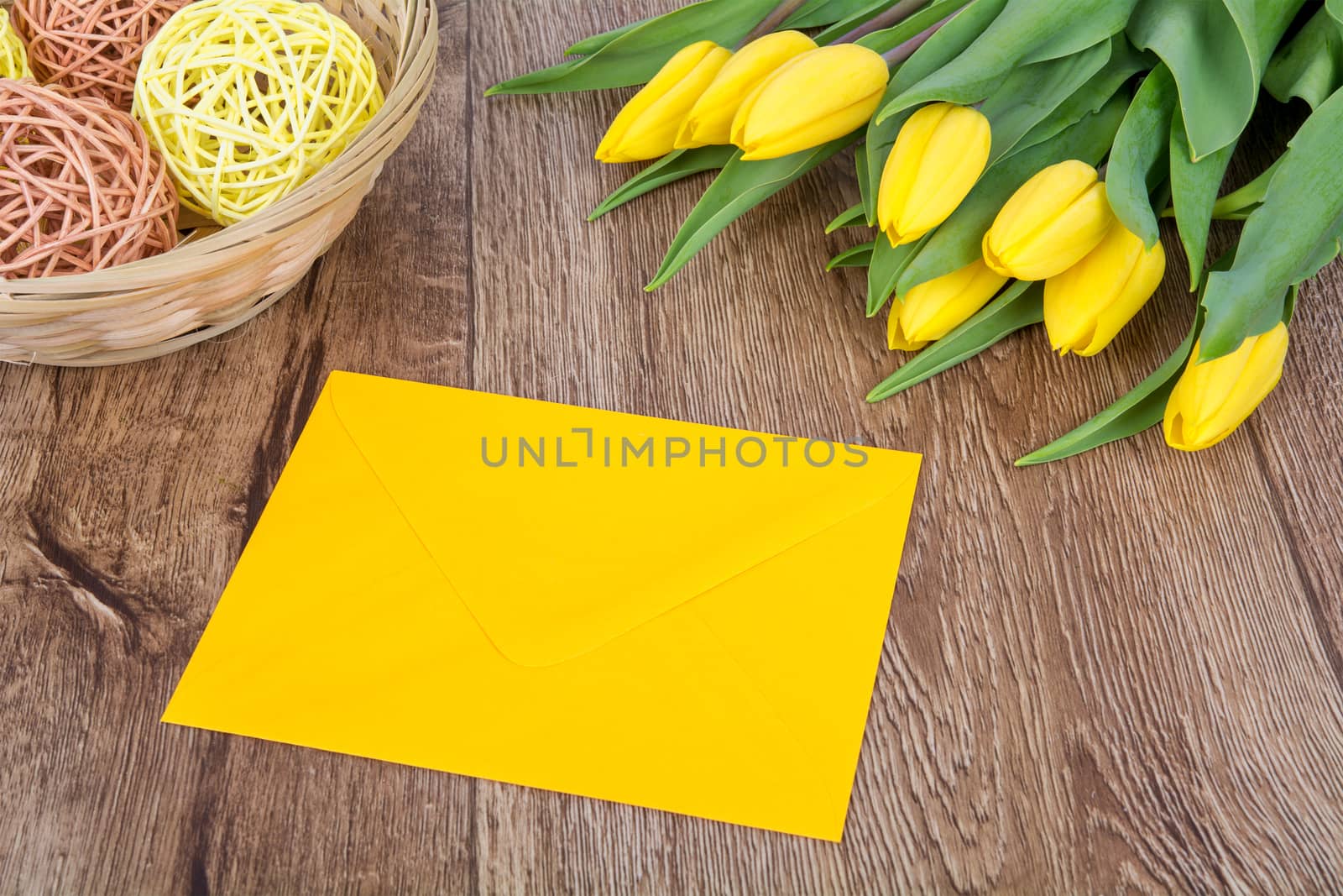 Yellow envelope with tulips on a table by neryx