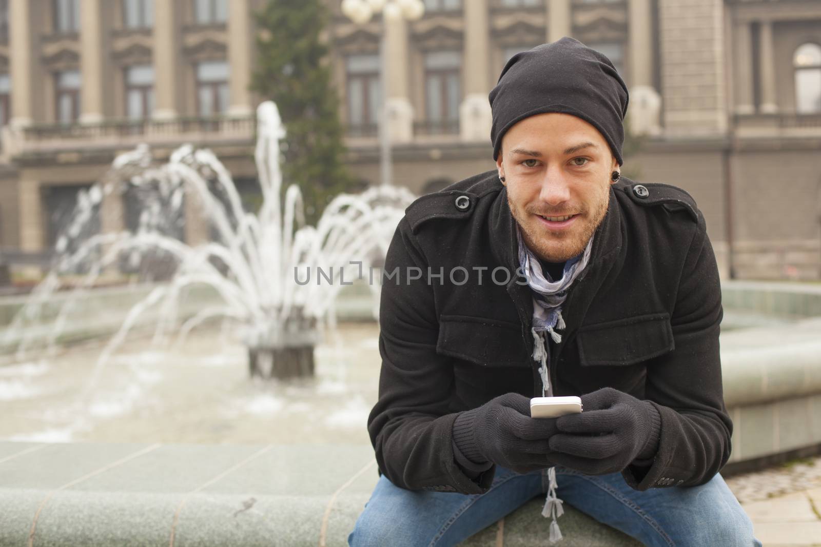 Young Man With Mobile Phone Joy In City by adamr