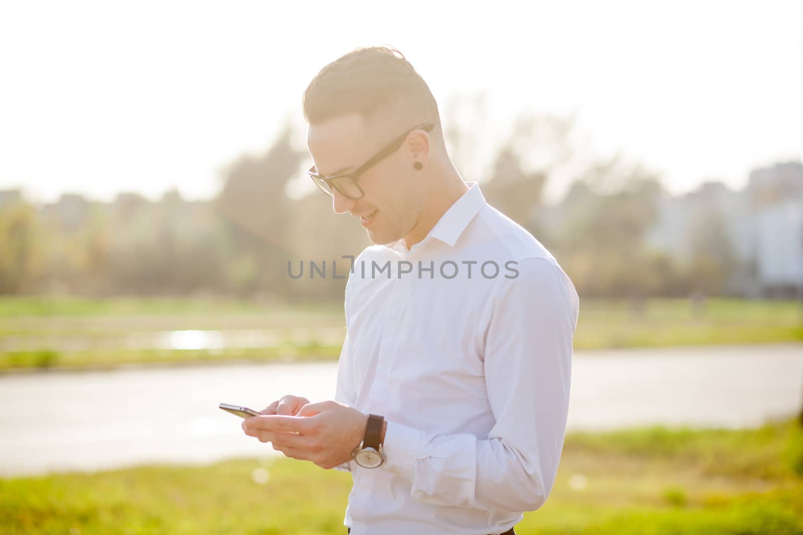Man with glasses speak on mobile phone, In City, Urban Space, Park