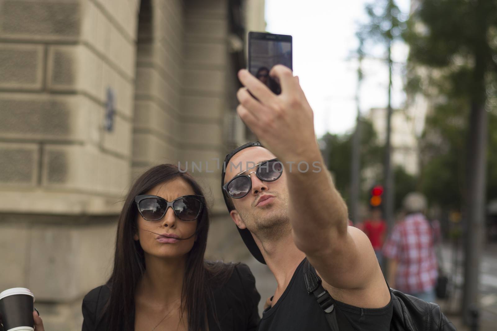Young couple taking selfies by adamr
