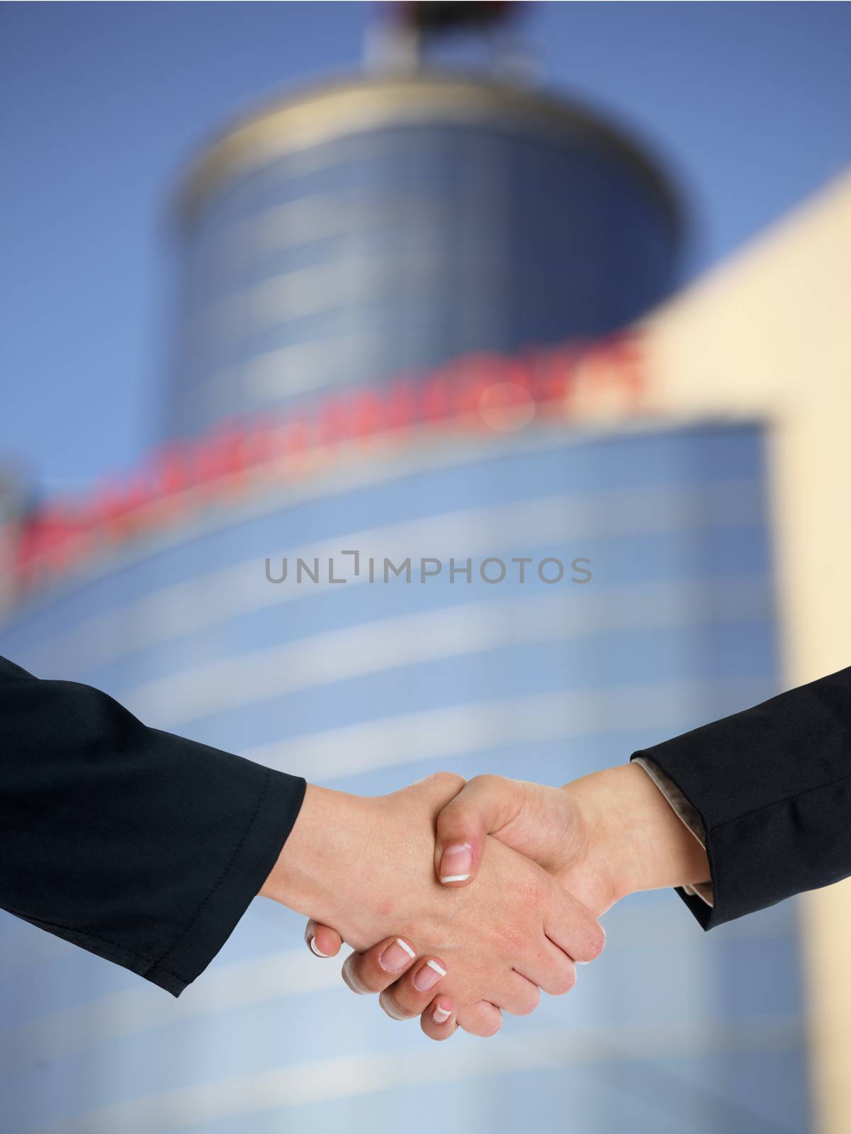 Architectural Handshaking in front of building by adamr