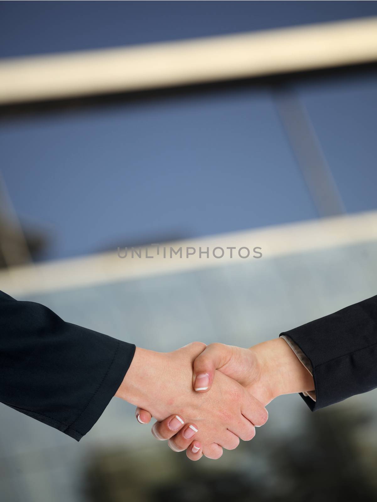 Architectural Handshaking in front of building by adamr