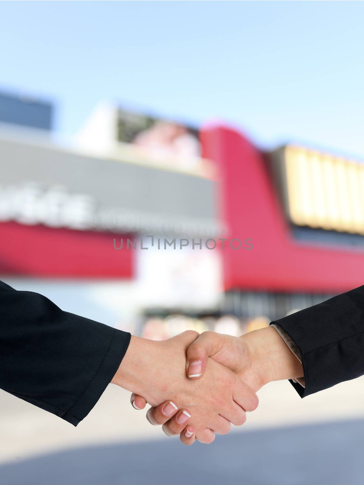 Architectural Handshaking in front of building by adamr