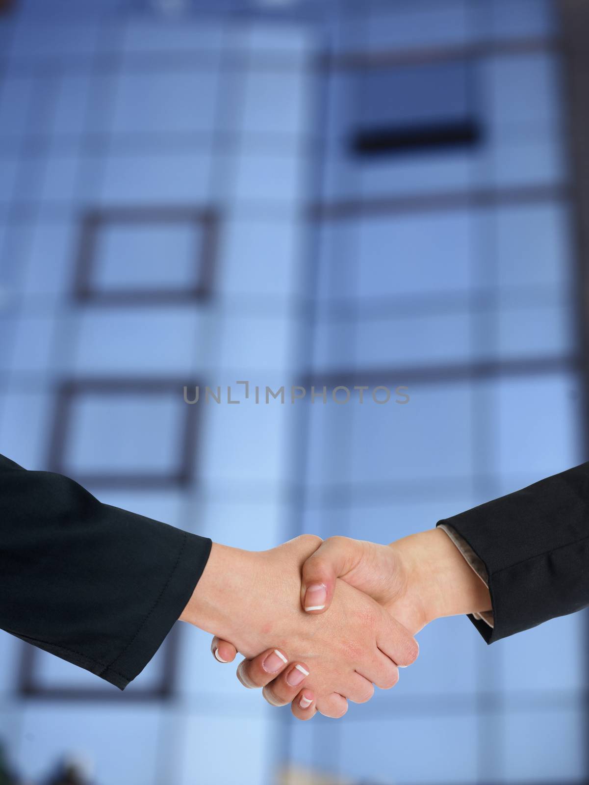 Handshake Handshaking and blured building in background