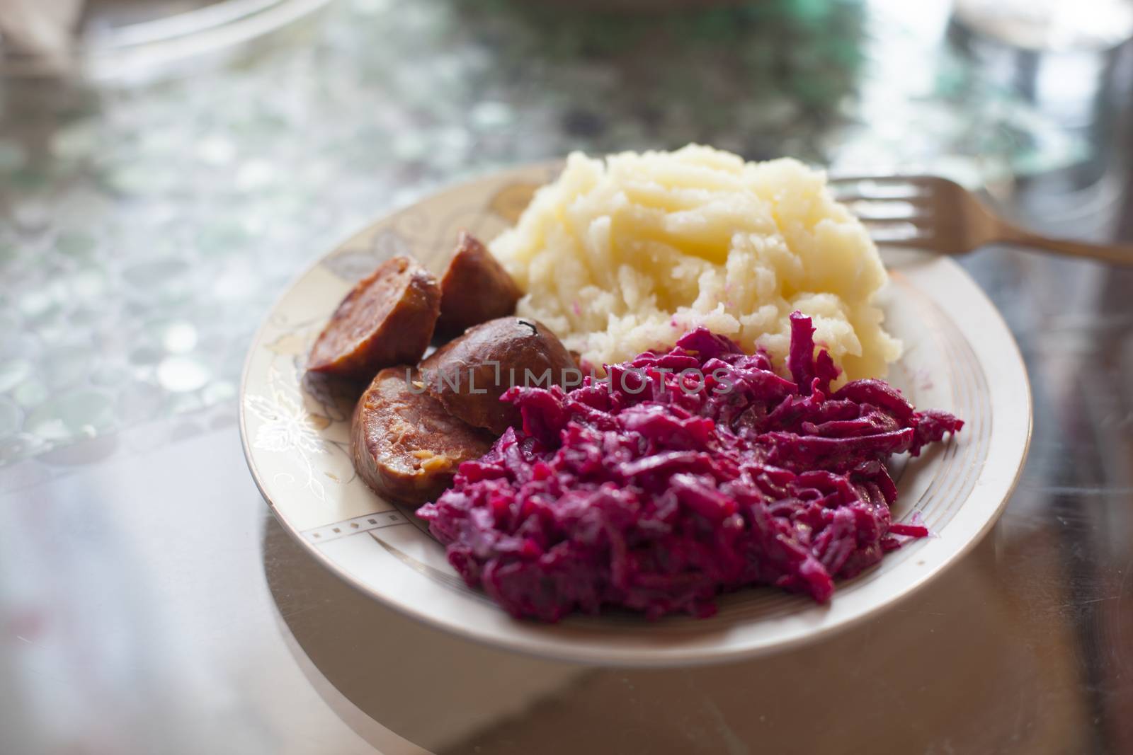Meat sausage with potato puree and salad of beet