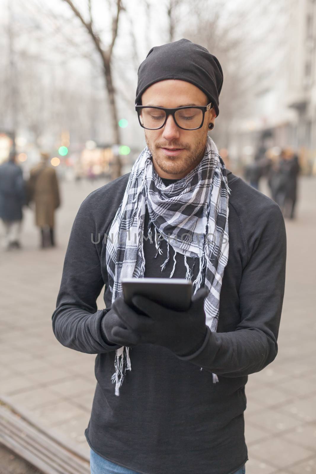 Man holdin i-pad tablet computer on street by adamr